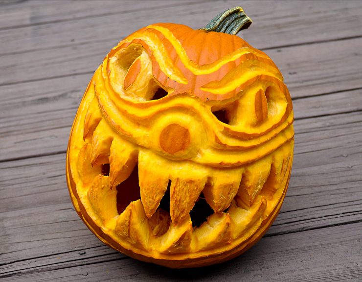 Hand carved Halloween pumpkin of spooky and scary clown face